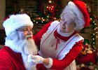 santaclaus1.JPG  Mrs. Claus adjusts Santa&#39;s beard and suit, while the Claus&#39;s were visiting in Spartanburg Friday  morning.