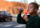 bubblekid.JPG  Charell McDowell, 7, blows bubbles in front of his home on Union St. in Spartanburg, SC Wednesday evening, March 6, 2002. (AP Photo/Spartanburg Herald-Journal/Tim Kimzey).