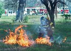 cowpensfire2.jpg  A firefighter tries to stomp out one of many grass fires that erupted from flying debris from the Cowpens mill fire in Cowpens Tuesday.